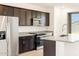 Modern kitchen features stainless steel appliances, granite countertops, and dark wood cabinetry at 4195 W Lisa Ln, San Tan Valley, AZ 85144