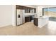 Open kitchen featuring stainless steel appliances, dark wood cabinetry, and granite countertops at 4195 W Lisa Ln, San Tan Valley, AZ 85144