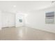 Bright living room features neutral tile flooring, white walls, and large windows for natural light at 4195 W Lisa Ln, San Tan Valley, AZ 85144