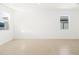 Bright living room features neutral tile flooring, white walls, and large windows for natural light at 4195 W Lisa Ln, San Tan Valley, AZ 85144