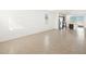 Bright living room featuring neutral tile flooring with an open concept to the kitchen at 4195 W Lisa Ln, San Tan Valley, AZ 85144