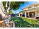 Outdoor space featuring a trampoline, patio seating, and a generous lawn, perfect for entertaining at 4530 E Decatur St, Mesa, AZ 85205