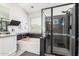 Modern bathroom featuring soaking tub and walk-in shower with sleek black and white tile at 4530 E Decatur St, Mesa, AZ 85205