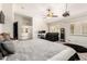 Spacious bedroom features plush carpet, ceiling fan, projector, and black leather seating at 4530 E Decatur St, Mesa, AZ 85205
