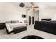 Bright bedroom features plush carpet, ceiling fan, projector, and black leather seating at 4530 E Decatur St, Mesa, AZ 85205