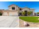 Charming two-story home featuring a three-car garage and well-manicured front yard with palm trees at 4530 E Decatur St, Mesa, AZ 85205