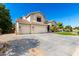 Side view of home with large driveway, three-car garage, tile roof and desert landscaping at 4530 E Decatur St, Mesa, AZ 85205