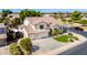 Aerial view of a beautiful two-story home with a tile roof, well-manicured lawn, and a three-car garage at 4530 E Decatur St, Mesa, AZ 85205