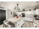 Spacious kitchen features white cabinets, granite counters, stainless appliances and modern lighting at 4530 E Decatur St, Mesa, AZ 85205