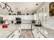 Beautiful kitchen with white cabinets, granite counters, stainless appliances, and modern fixtures at 4530 E Decatur St, Mesa, AZ 85205