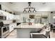 Well-appointed kitchen with white cabinets, granite countertops, stainless appliances, and backyard views at 4530 E Decatur St, Mesa, AZ 85205
