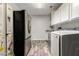 Spacious laundry room with stainless steel refrigerator and wood-look floors and new washer dryer at 4530 E Decatur St, Mesa, AZ 85205