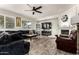 Comfortable living room featuring stylish tile floors, a cozy fireplace, and plenty of natural light at 4530 E Decatur St, Mesa, AZ 85205