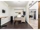 Office with dark wood floors, crown molding, desk, chair, and view into another room at 4530 E Decatur St, Mesa, AZ 85205