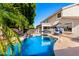 Beautiful swimming pool with umbrellas in a backyard with patio and covered lounge areas, perfect for outdoor living at 4530 E Decatur St, Mesa, AZ 85205