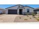 Charming single-story home featuring a stone-accented entrance and a low-maintenance desert landscape at 4811 W Hunter Trl, San Tan Valley, AZ 85144