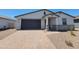 Inviting single-story home showcasing a brick-paved driveway and well-maintained desert landscaping at 4811 W Hunter Trl, San Tan Valley, AZ 85144