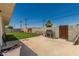 Fenced backyard with a well-maintained lawn, patio, and a modern stainless steel gas grill at 505 S Ridge --, Mesa, AZ 85204