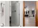 Bathroom with a frosted glass shower enclosure, tile floor, and access to main bedroom at 505 S Ridge --, Mesa, AZ 85204
