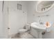 Bright bathroom with pedestal sink, toilet, framed mirror, and tiled floors at 505 S Ridge --, Mesa, AZ 85204
