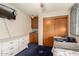 Bedroom with a ceiling fan, blue carpet, white dresser and wooden closet doors at 505 S Ridge --, Mesa, AZ 85204