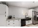Updated kitchen with white cabinets, granite countertops, and a black farmhouse sink at 505 S Ridge --, Mesa, AZ 85204