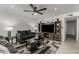 Open living room with sofas, entertainment center, geometric rug and ceiling fan at 505 S Ridge --, Mesa, AZ 85204