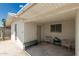 Covered patio area, featuring white walls, chairs and bench at 505 S Ridge --, Mesa, AZ 85204