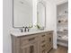 Bright bathroom featuring a double vanity with marble countertop, large mirrors, and stylish black faucets at 5401 E Van Buren St # 1088, Phoenix, AZ 85008