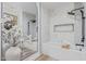 Luxurious bathroom featuring marble tile, a soaking tub, a rain shower, and a sleek mirror at 5401 E Van Buren St # 1088, Phoenix, AZ 85008