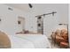 Modern bedroom features a cozy chair, walk-in closet, ceiling fan, and a connecting door to a private bathroom at 5401 E Van Buren St # 1088, Phoenix, AZ 85008