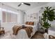 Bright bedroom featuring a ceiling fan, cozy brown decor, and a sliding closet with open shelf storage at 5401 E Van Buren St # 1088, Phoenix, AZ 85008