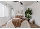 Cozy bedroom with decor, mirrors, hardwood flooring, white walls, and a large window at 5401 E Van Buren St # 1088, Phoenix, AZ 85008