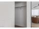 Spacious walk-in closet featuring ample storage and a mirror reflecting the bedroom at 5401 E Van Buren St # 1088, Phoenix, AZ 85008