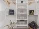 Well-organized closet with white shelves, decorative boxes, floral accents, and stylish accessories at 5401 E Van Buren St # 1088, Phoenix, AZ 85008