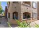 Exterior view of condo building displaying balconies, stucco facade, and desert landscaping at 5401 E Van Buren St # 1088, Phoenix, AZ 85008