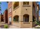 Exterior view of condo building showing terraces, balconies, stucco siding, windows, and desert landscaping at 5401 E Van Buren St # 1088, Phoenix, AZ 85008
