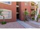 Exterior view of multi-story condo building showcasing balconies, stairs, and mature palm trees at 5401 E Van Buren St # 1088, Phoenix, AZ 85008