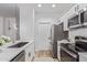 Modern kitchen with stainless steel appliances, white cabinetry, and quartz countertops at 5401 E Van Buren St # 1088, Phoenix, AZ 85008