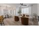 Open-concept living room with light wood floors, white walls, and neutral-toned furniture at 5401 E Van Buren St # 1088, Phoenix, AZ 85008