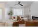 Bright living room with a ceiling fan, a decorative fireplace, and white sheer curtains at 5401 E Van Buren St # 1088, Phoenix, AZ 85008