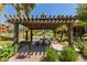 Inviting picnic area featuring a grill and shaded pergola with lush landscaping, offering a perfect spot for outdoor gatherings at 5401 E Van Buren St # 1088, Phoenix, AZ 85008
