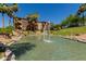 Scenic view of a water feature with a fountain and waterfall, set against a backdrop of lush landscaping and residential buildings at 5401 E Van Buren St # 1088, Phoenix, AZ 85008