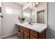 Bathroom featuring a large mirror, wood cabinets, neutral walls, and granite counters, offering a clean and modern feel at 5534 W Riviera Dr, Glendale, AZ 85304