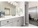 Bathroom showcasing a stylish vanity with ample storage and a well-lit mirror at 5534 W Riviera Dr, Glendale, AZ 85304