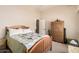 Cozy bedroom with wooden furniture and a colorful quilt, providing a warm and inviting atmosphere at 5534 W Riviera Dr, Glendale, AZ 85304