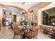 Breakfast nook showcasing a glass table, archway, and access to the kitchen and living areas at 5534 W Riviera Dr, Glendale, AZ 85304