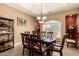 Elegant dining room with a large table, decorative lighting, and views to the outside at 5534 W Riviera Dr, Glendale, AZ 85304