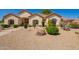 Expansive front yard featuring desert landscaping, large boulders and well-manicured shrubbery at 5534 W Riviera Dr, Glendale, AZ 85304