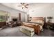 Large primary bedroom featuring a fireplace, sitting area, and wood furnishings at 5534 W Riviera Dr, Glendale, AZ 85304